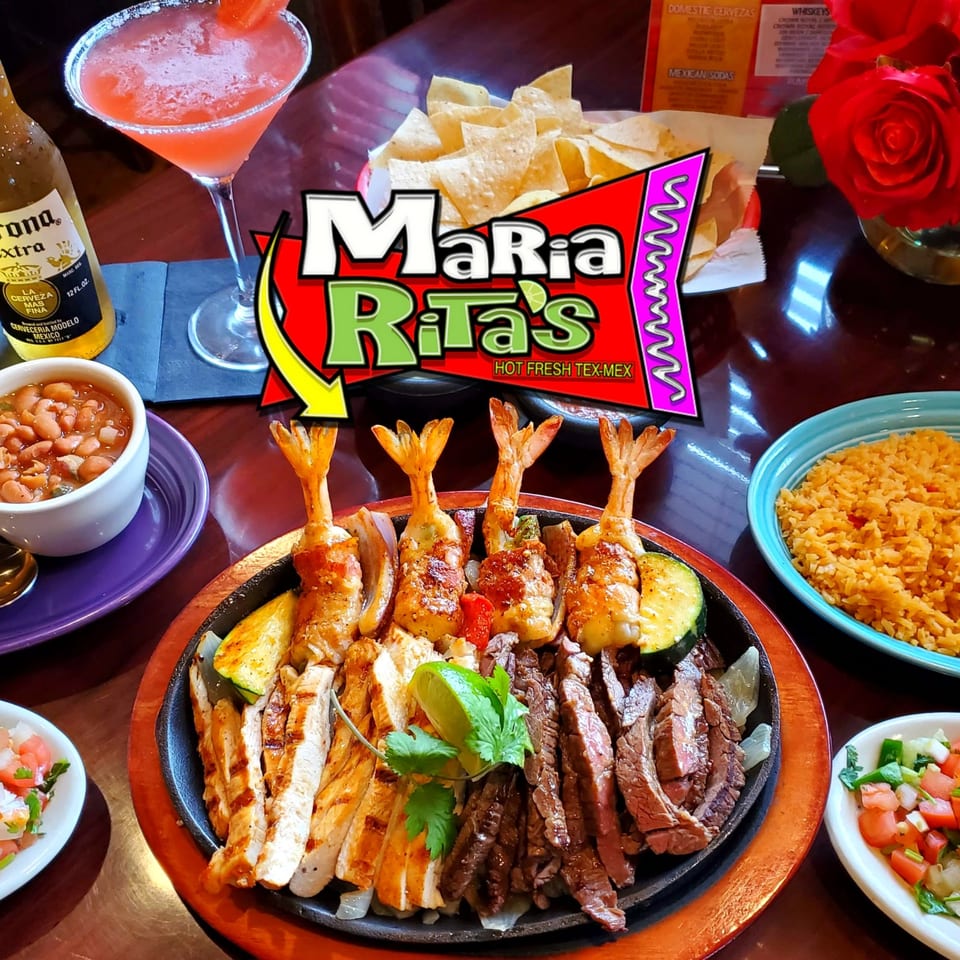 Maria Rita's sizzling fajitas with shrimp, chicken, steak, rice, beans, and a margarita.