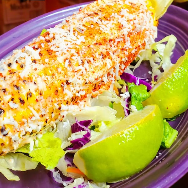 Maria Rita's Tex-Mex elote, a grilled corn on the cob with cheese, chili powder, and lime.