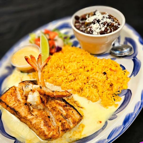 Maria Rita's Tex-Mex grilled fish and shrimp with yellow rice, black beans, and salsa.