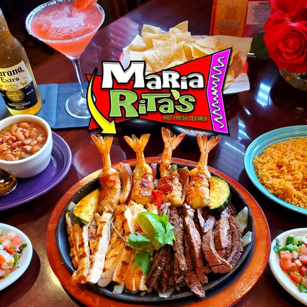 Maria Rita's sizzling fajita platter with shrimp, chicken, steak, rice, beans, and drinks.