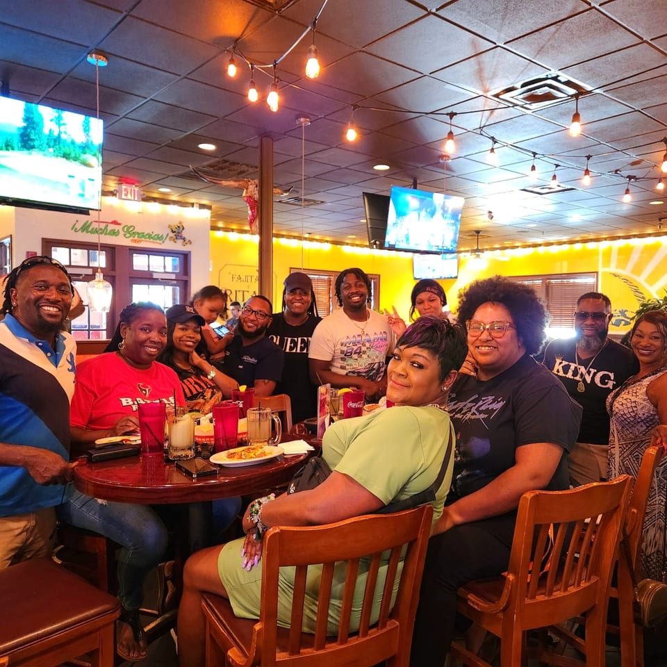 A large group of happy customers enjoying a meal together at Maria Rita's Tex-Mex restaurant.