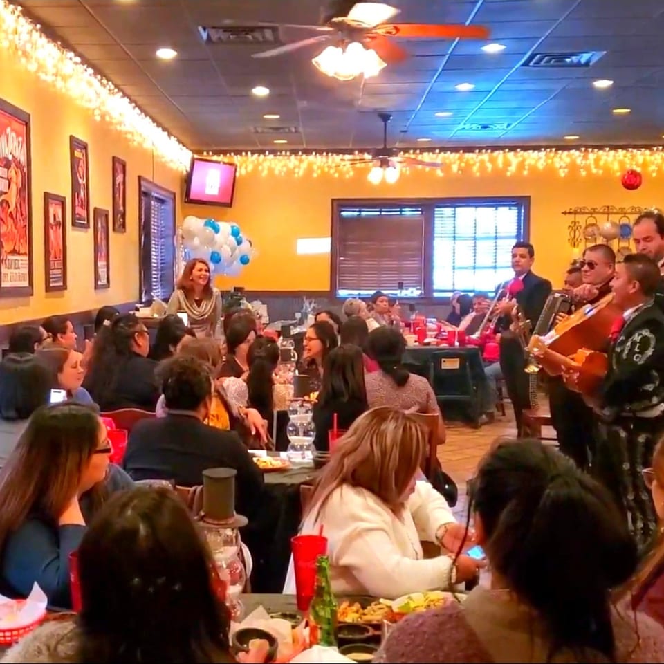 A mariachi band performs for diners in a lively Maria Rita's Tex-Mex restaurant.